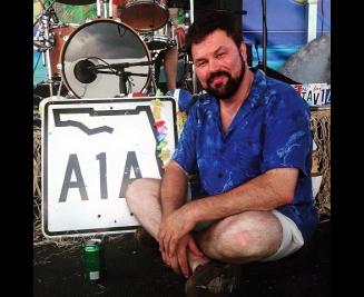 Jeff pike in front of a sign