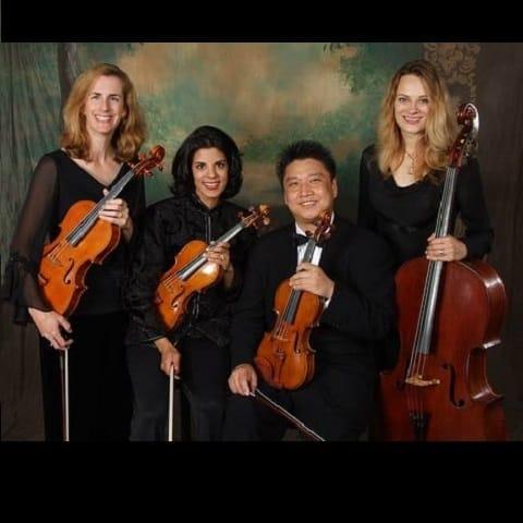 The band posing for a picture with their instruments