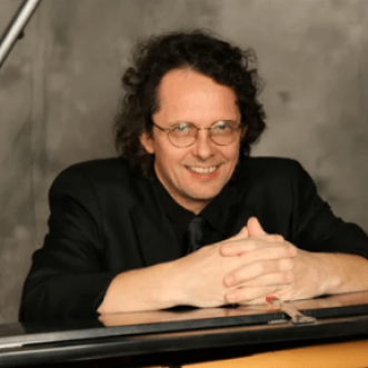 Andrew Faz sitting at the piano