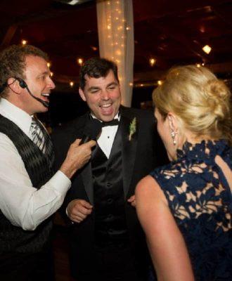 dj rob talking to a guest and the party host
