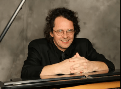 Andrew Faz sitting at the piano