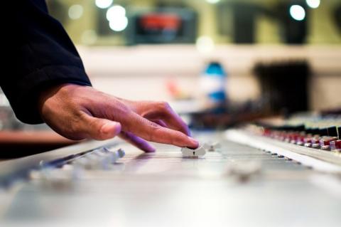 A hand on a dj board 