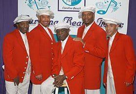 The Tams wearing red suit coats