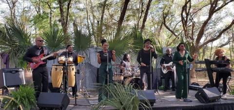 The Upscale Party Band performs outdoors at a private country club event.