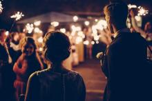 A wedding with guest holding sparklers 