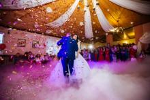 A bride and groom surrounded by confetti 