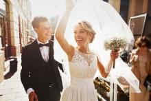 A bride and groom smiling 